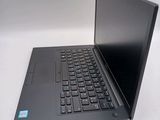 a laptop with a black keyboard on a white surface
