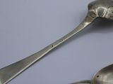 two spoons and a spoon on a table