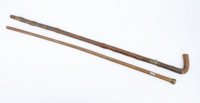 pair of wooden canes with handles on a white surface