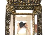a person taking a picture in a mirror with a camera