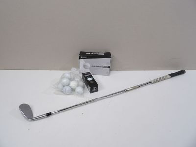 a golf club and a box of golf balls on a table