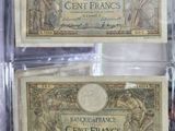 two old french currency notes are in a clear plastic case