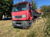 a red truck that is parked in the grass