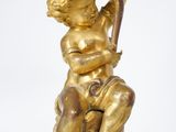 an image of a gold statue of a boy with a bird on his shoulder