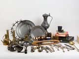 a lot of silver and brass items on a table
