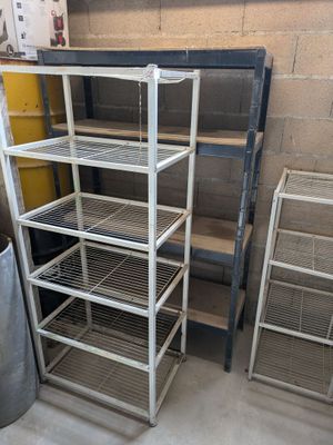 many shelves that are in the corner of a room
