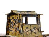 a small toy horse drawn carriage sitting on a table