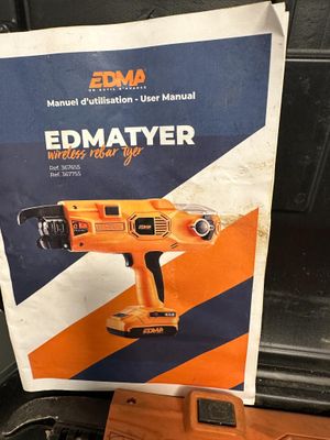 an orange and black electric tool sitting on top of a wooden table