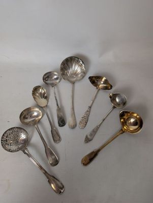 a lot of silver spoons and spoon spoons on the table