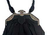 an image of a black purse on a white background
