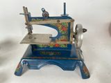 a small blue sewing machine on a white table