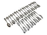 many forks and spoons laid out on a white surface