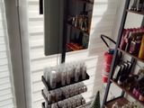 a shelf with bottles of cosmetics and a mirror in the room