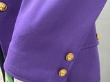 a close up of a purple jacket and green skirt on a mannequin mannequin mannequin mannequin mannequin mannequin manne