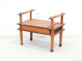 a small wooden bench with a wooden seat on it