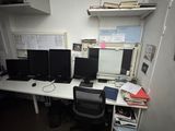 a desk with two monitors and a computer on it