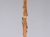 an orange and black pen with writing on it sitting on a clear surface