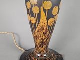a black and gold lamp that is sitting on a table