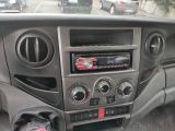 a radio in the center of a car with other cars in the background