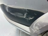 a close up of a car ' s front bumper with a denting on it