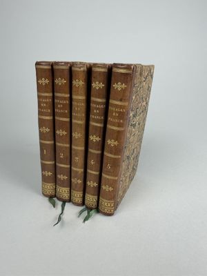 trois livres sont empilés sur une surface blanche