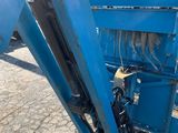 an image of a blue dump truck parked on the side of the road