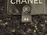 chanel label on a black jacket with multicolored sequins