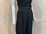the mannequin is wearing a black jumpsuit and a black top