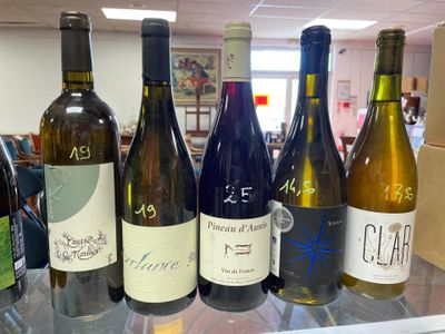 several bottles of wine are lined up on a counter in a store