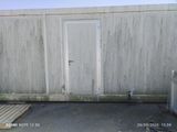 a white door that is on the side of a building