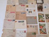 a large collection of old postcards and envelopes laid out on a table