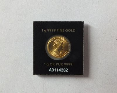 a close up of a gold coin on a white surface