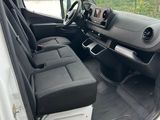 the interior of a white van with black seats and a steering wheel