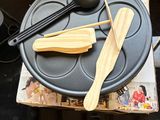 someone is taking a picture of a table with a pan, spoon, and spatula on it