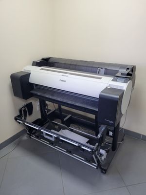 an image of a large printer in the corner of a room