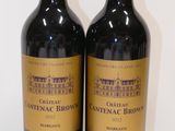 two bottles of wine sitting next to each other on a table