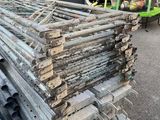 a pile of wood sitting on the ground next to a truck