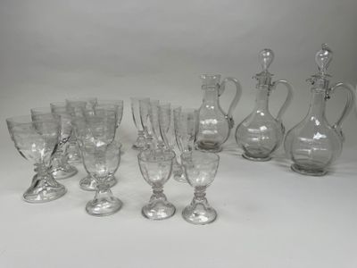 a lot of wine glasses and a pitcher on the table