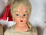 three dolls that are sitting next to each other on a table