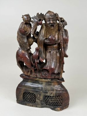 an old bronze statue of a group of people on a pedestal
