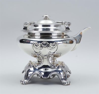 a silver plated teapot on a stand with a lid