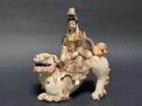 chinese figurine of a woman riding on a camel with a dog
