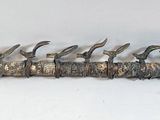 a metal object that has a bunch of birds on it