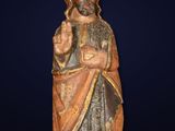 a wooden statue of a man with a beard and a robe