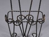 a metal basket that has a handle on it