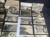 several old black and white photographs of people and vehicles on a table