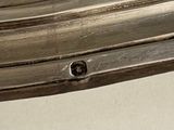 a close up of a silver plate with a flower on it