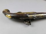 a very old gun that is sitting on a table