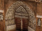 a small model of a building with statues on it