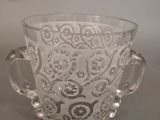 a glass cup with a handle on a table
